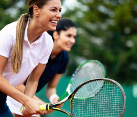 Happy fit people playing tennis together. Sport concept